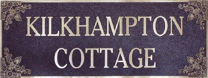 Custom bronze house plaque reading “Kilkhampton Cottage,” designed for outdoor mounting on heritage homes.