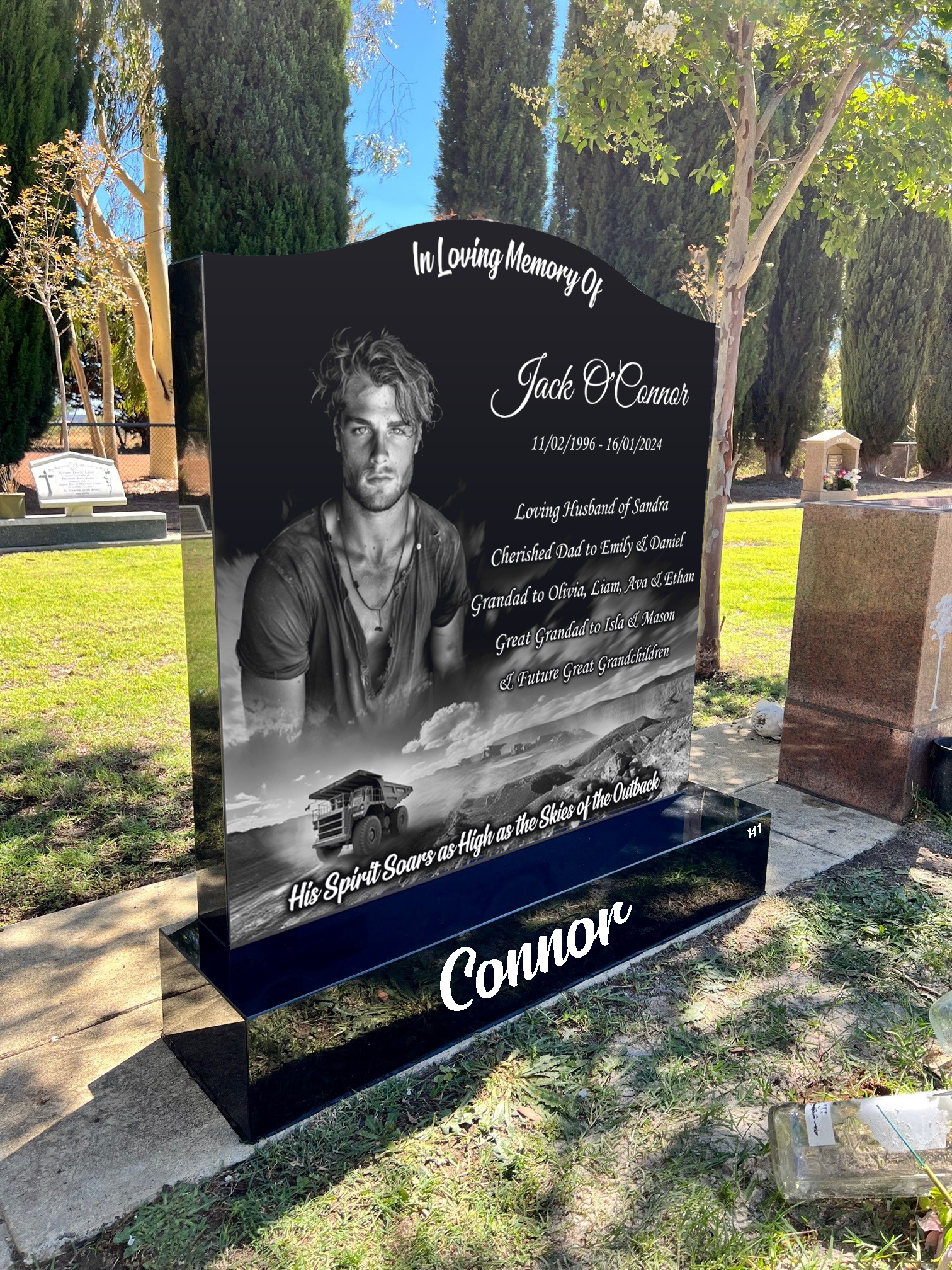 Black granite laser-etched headstone featuring detailed engraving and polished finish – ideal for personalized memorials, cemetery grave markers, or elegant commemorative tributes.