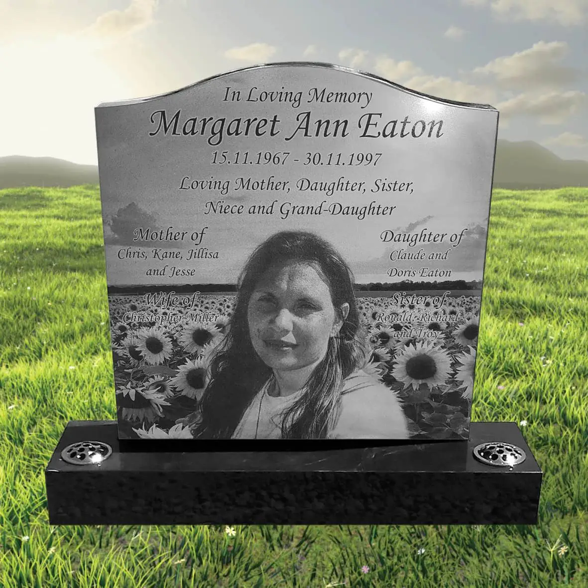 Laser-etched black granite headstone featuring detailed portrait and inscription, designed for long-lasting memorial use with high-contrast engraving.