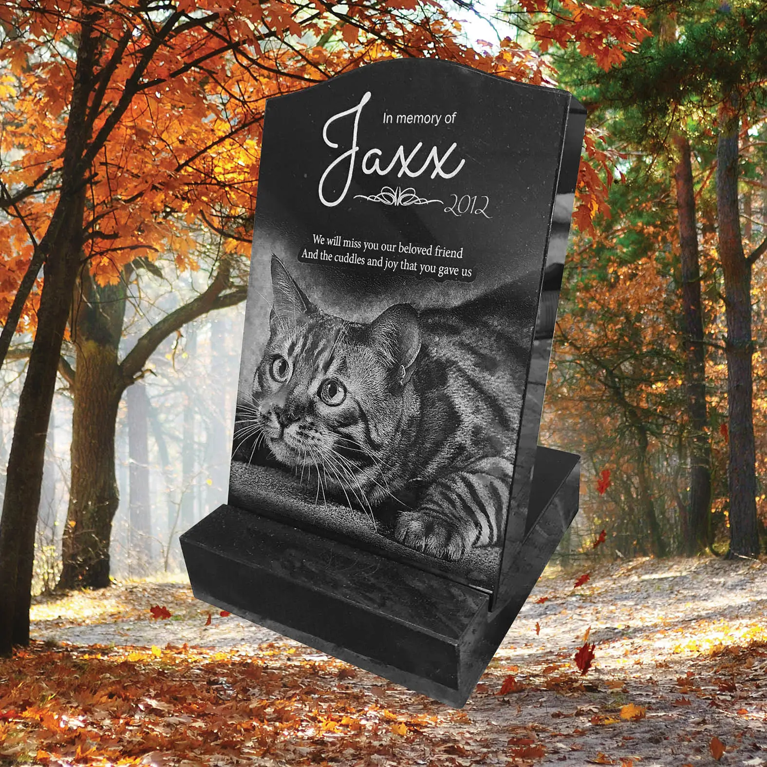 Laser-etched black granite pet mini headstone engraved with portrait of pet ‘Jaxx’, name ‘Jaxx’ and tribute text, accented with paw‑print motif and decorative border, polished finish.